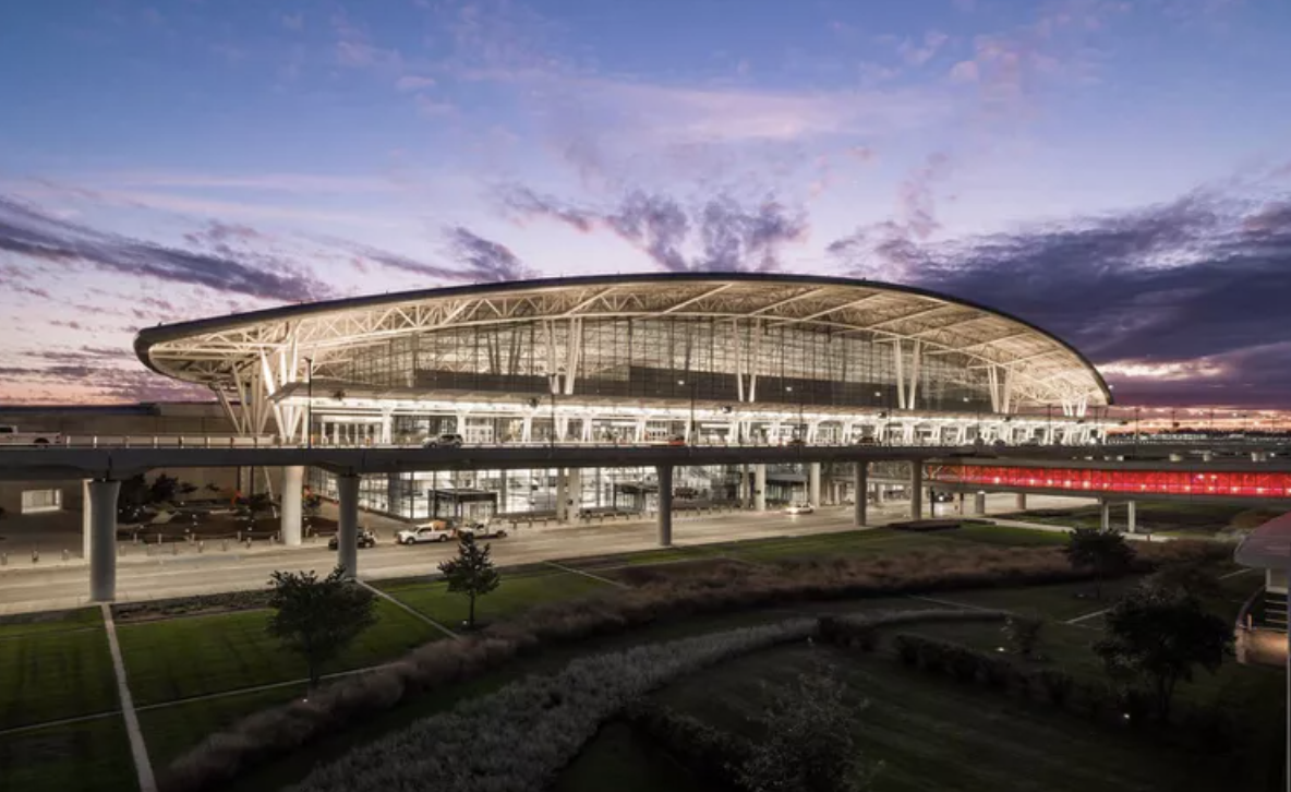 Outside view of the Indy airport with curved building and sun set clouds behind