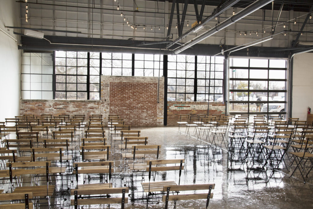 Wedding ceremony area with exposed brick and windows.